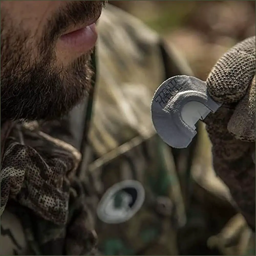 a hunter using a mouth turkey call